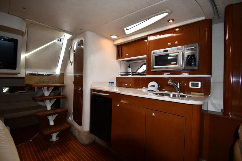 Slide: The Image of Interior of 2009 Sea Ray 330 Sundancer yacht with kitchenette and wooden cabinetry. - 32