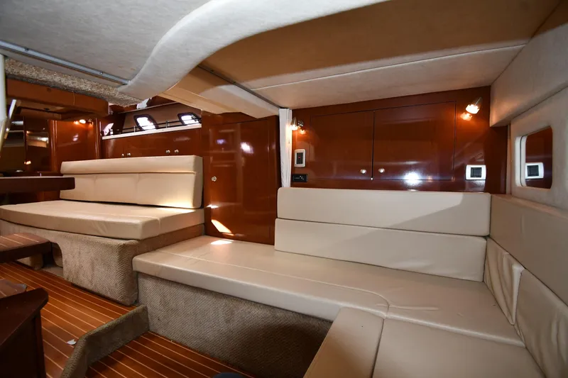 Slide: The Image of Luxurious interior of 2009 Sea Ray 330 Sundancer yacht with plush seating and wood accents. - 40