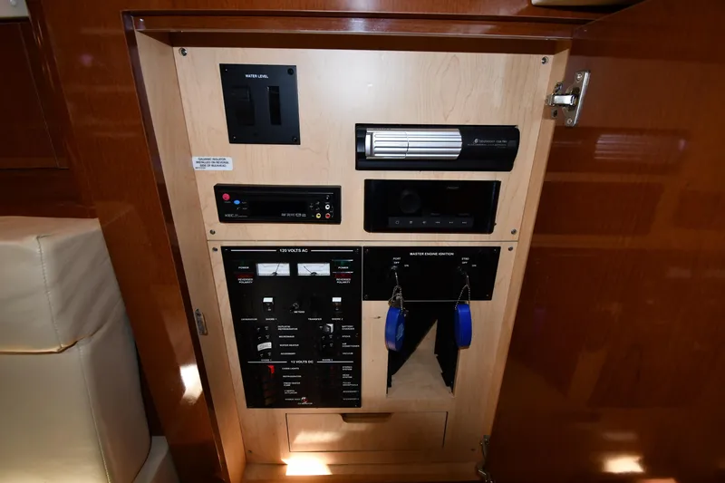 Slide: The Image of Control panel inside 2009 Sea Ray 330 Sundancer yacht, featuring various switches and gauges. - 43