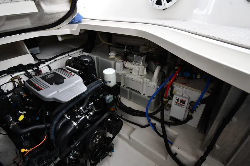 Slide: The Image of Engine compartment of a 2009 Sea Ray 330 Sundancer, showcasing mechanical components and wiring. - 48