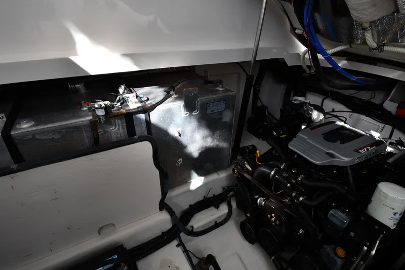 Slide: The Image of Engine compartment of 2009 Sea Ray 330 Sundancer boat, showcasing mechanical components. - 49