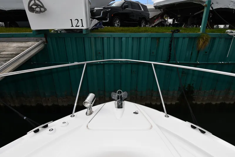 Slide: The Image of Bow view of 2009 Sea Ray 330 Sundancer docked near a green wall. - 5