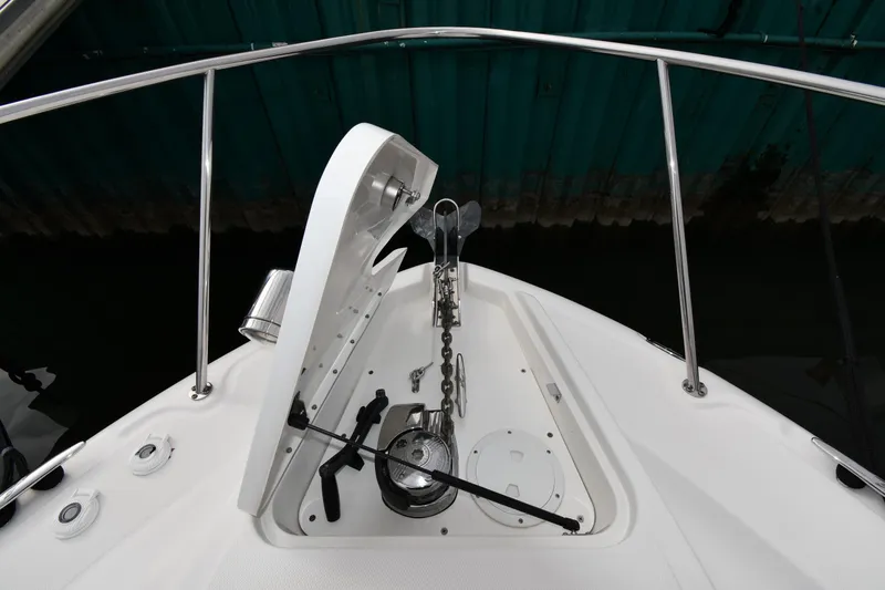 Slide: The Image of Anchor compartment of 2009 Sea Ray 330 Sundancer boat with open hatch and chain. - 6