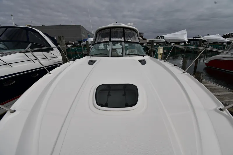 Slide: The Image of 2009 Sea Ray 330 Sundancer yacht docked at marina under cloudy sky. - 7