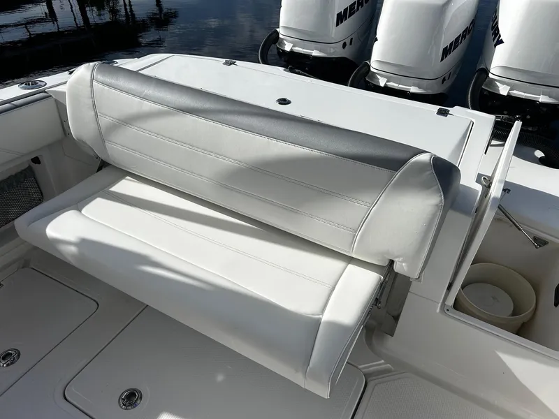 Slide: The Image of 2021 Nor-Tech 390 Sport Center Console boat with white and gray seating. - 11