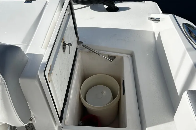 Slide: The Image of Open storage compartment on a 2021 Nor-Tech 390 Sport Center Console boat. - 13