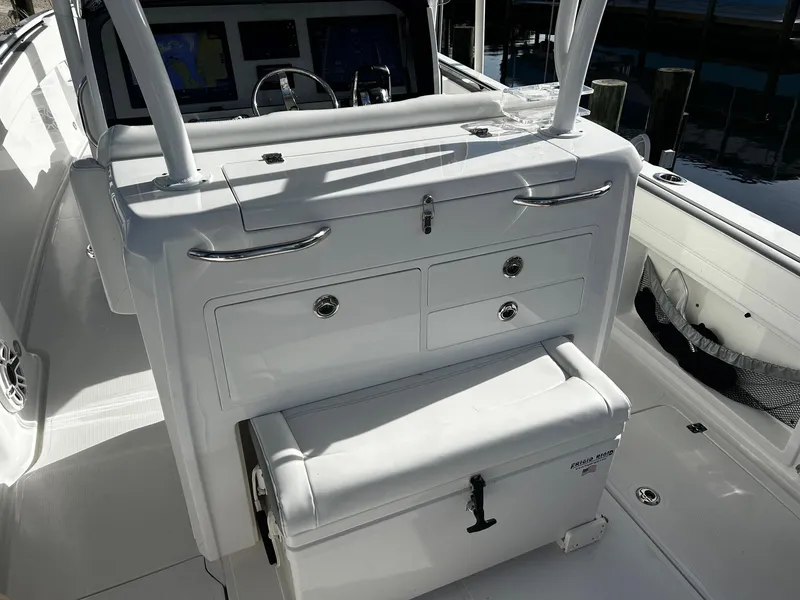 Slide: The Image of 2021 Nor-Tech 390 Sport Center Console interior with storage compartments and seating. - 15