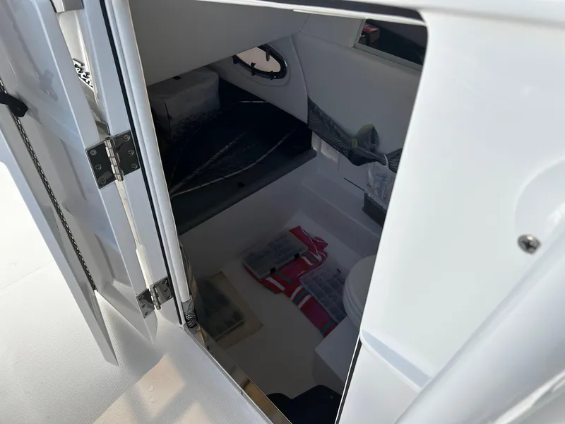 Slide: The Image of 2021 Nor-Tech 390 Sport Center Console cabin interior with storage and seating. - 17
