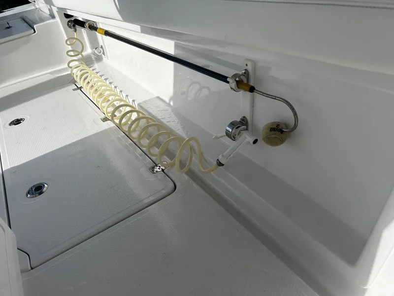 Slide: The Image of 2021 Nor-Tech 390 Sport Center Console deck with coiled hose and storage compartments. - 18