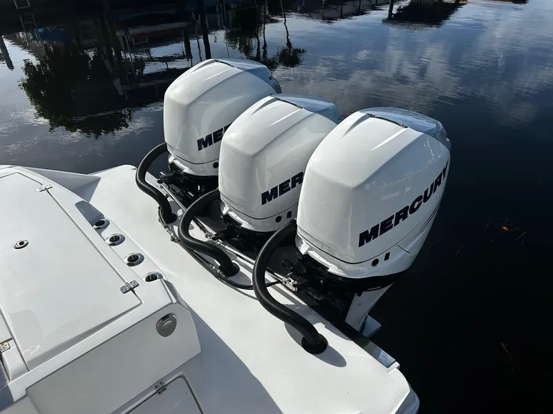 Slide: The Image of 2021 Nor-Tech 390 Sport Center Console with triple Mercury outboard engines. - 21