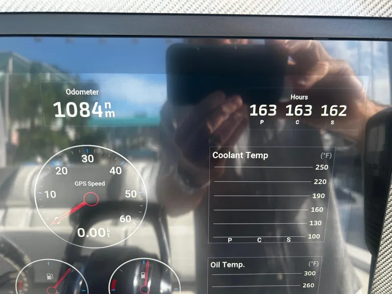 Slide: The Image of Close-up of 2021 Nor-Tech 390 Sport Center Console dashboard displaying odometer and engine hours. - 24