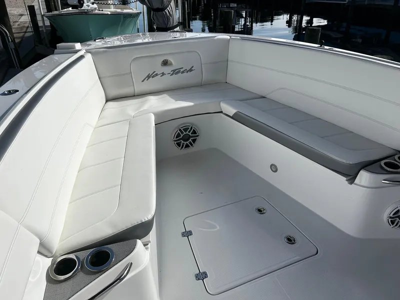 Slide: The Image of 2021 Nor-Tech 390 Sport Center Console boat with white seating and storage compartments. - 4