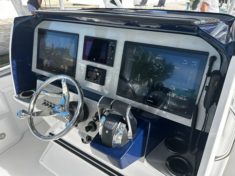 Slide: The Image of 2021 Nor-Tech 390 Sport Center Console helm with advanced navigation displays and controls. - 6