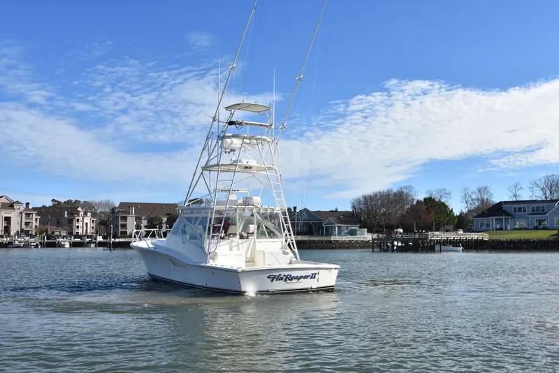 Slide: The Image of 2006 Albemarle 41 Express boat on water near residential area. - 10