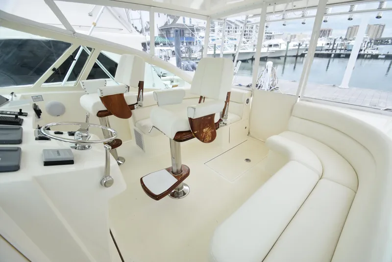 Slide: The Image of 2006 Albemarle 41 Express yacht cockpit with white seating and helm station. - 14