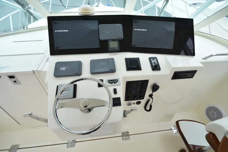 Slide: The Image of 2006 Albemarle 41 Express helm with Furuno electronics and CAT engine controls. - 17
