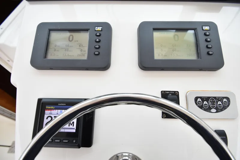Slide: The Image of Dashboard of a 2006 Albemarle 41 Express boat with CAT and Garmin displays. - 20