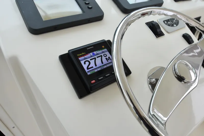 Slide: The Image of Close-up of 2006 Albemarle 41 Express boat dashboard with Garmin display and steering wheel. - 21