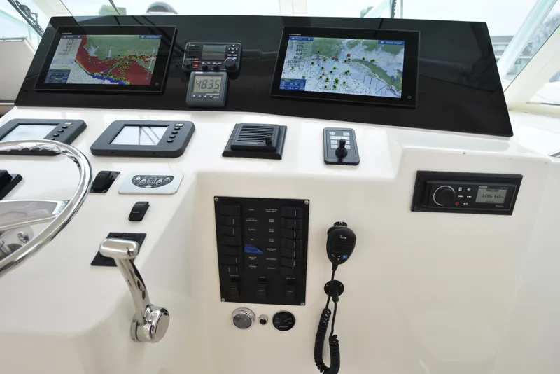 Slide: The Image of 2006 Albemarle 41 Express helm with navigation screens and control panel. - 22