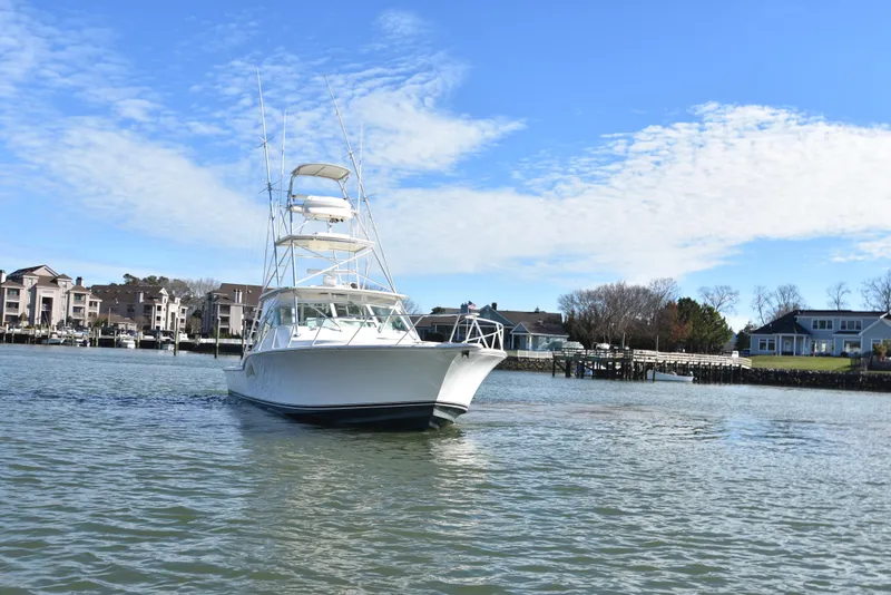 Slide: The Image of 2006 Albemarle 41 Express boat on water near residential docks. - 3