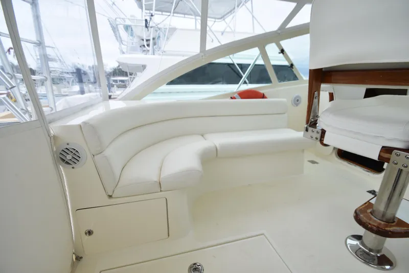 Slide: The Image of 2006 Albemarle 41 Express boat interior with white seating and chair. - 35