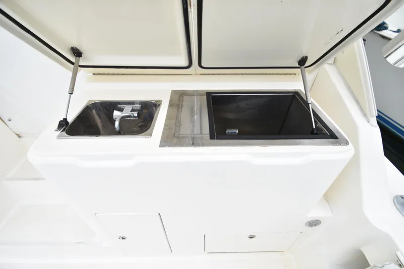 Slide: The Image of 2006 Albemarle 41 Express boat sink and storage compartment. - 38