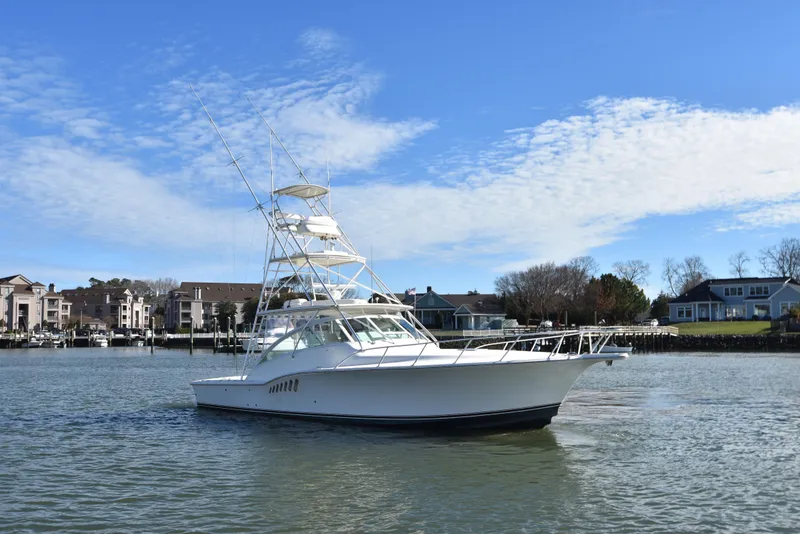 Slide: The Image of 2006 Albemarle 41 Express boat on calm water near residential area. - 4
