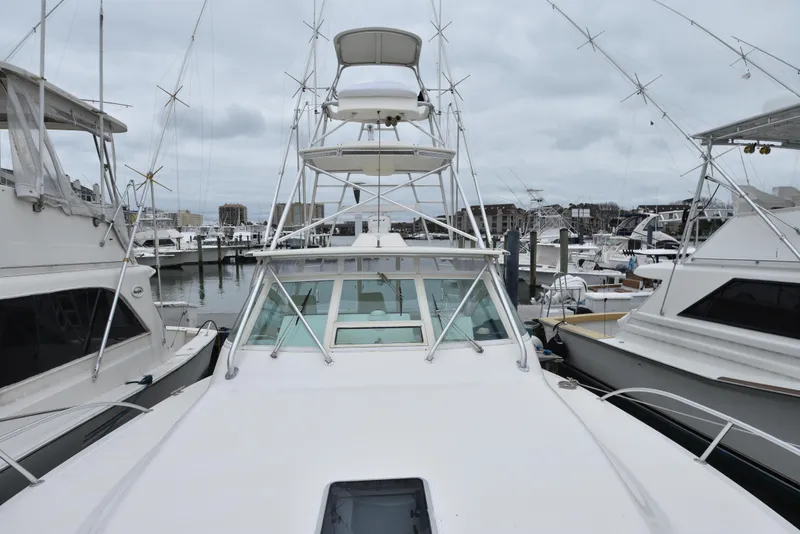 Slide: The Image of 2006 Albemarle 41 Express yacht docked at a marina. - 44