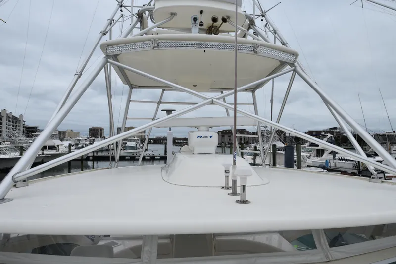 Slide: The Image of 2006 Albemarle 41 Express boat docked at a marina, view of the tower and deck. - 47