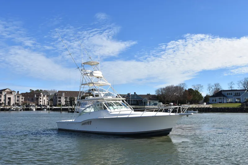 Slide: The Image of 2006 Albemarle 41 Express boat on calm water near residential area. - 5