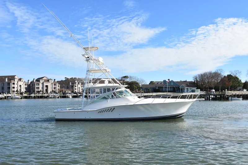 Slide: The Image of 2006 Albemarle 41 Express yacht cruising near waterfront homes. - 6