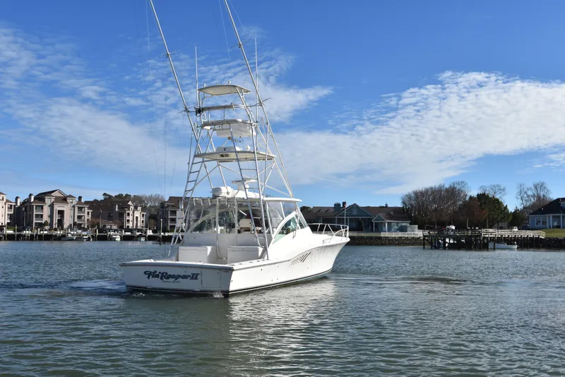 Slide: The Image of 2006 Albemarle 41 Express boat cruising near waterfront homes. - 7