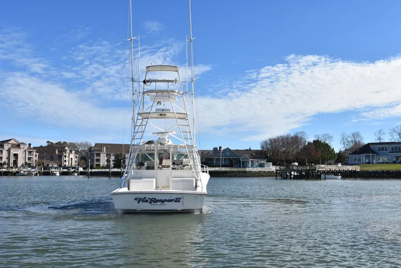 Slide: The Image of 2006 Albemarle 41 Express boat on water near residential area. - 9