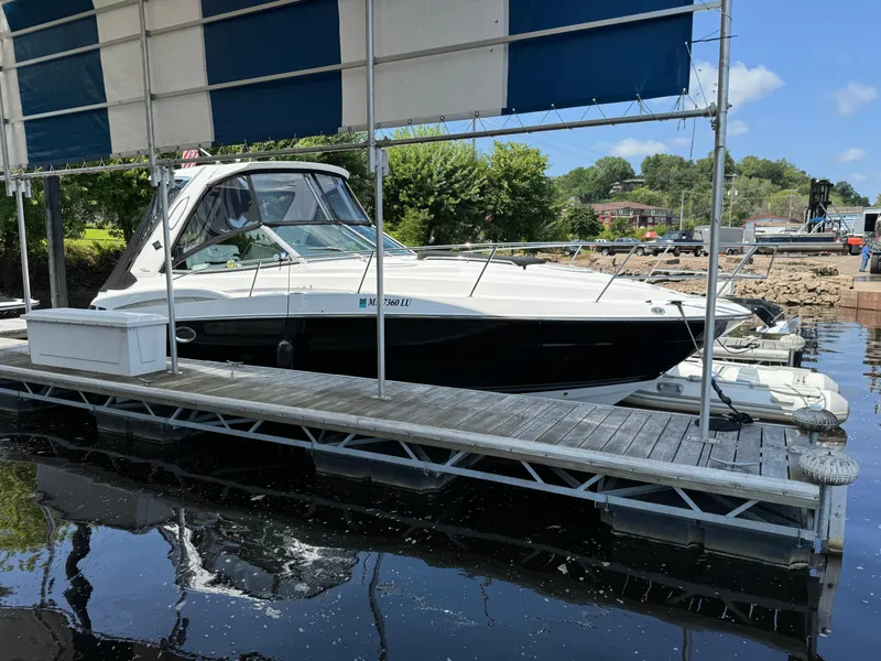 The Image of 2019 Monterey 335 SY boat docked on calm water under a canopy. - 0