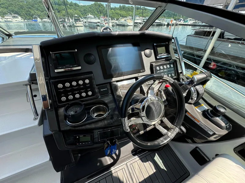 Slide: The Image of Cockpit of 2019 Monterey 335 SY boat with modern controls and steering wheel. - 10