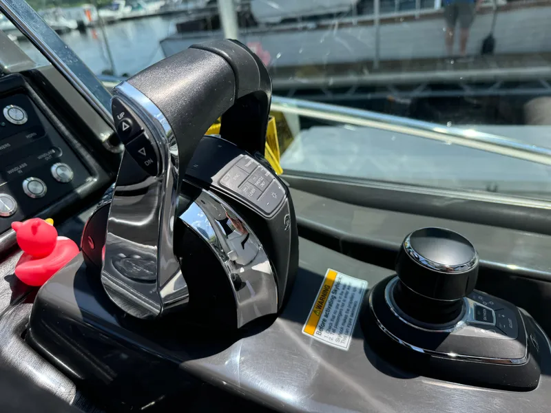 Slide: The Image of Control panel of a 2019 Monterey 335 SY boat with throttle and joystick. - 14