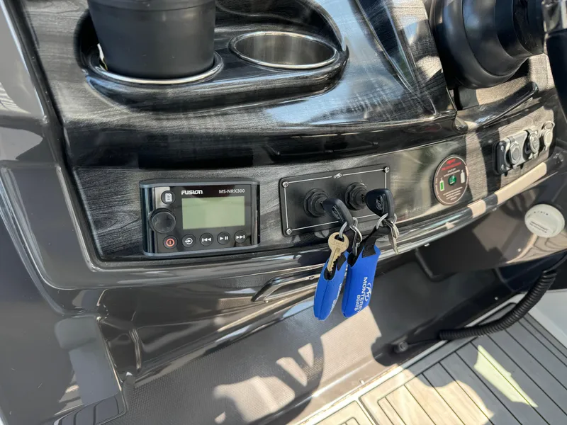 Slide: The Image of Control panel of a 2019 Monterey 335 SY boat with keys and audio system. - 15