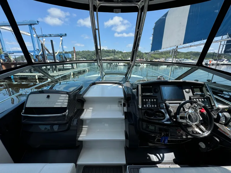 Slide: The Image of 2019 Monterey 335 SY yacht cockpit with modern controls and panoramic view. - 16