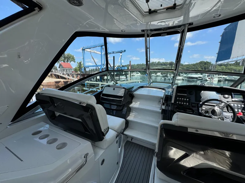 Slide: The Image of 2019 Monterey 335 SY boat interior with modern dashboard and seating. - 20
