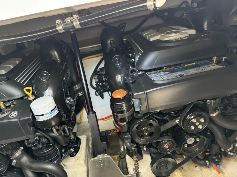 Slide: The Image of Engine compartment of a 2019 Monterey 335 SY boat, showcasing dual engines and components. - 21