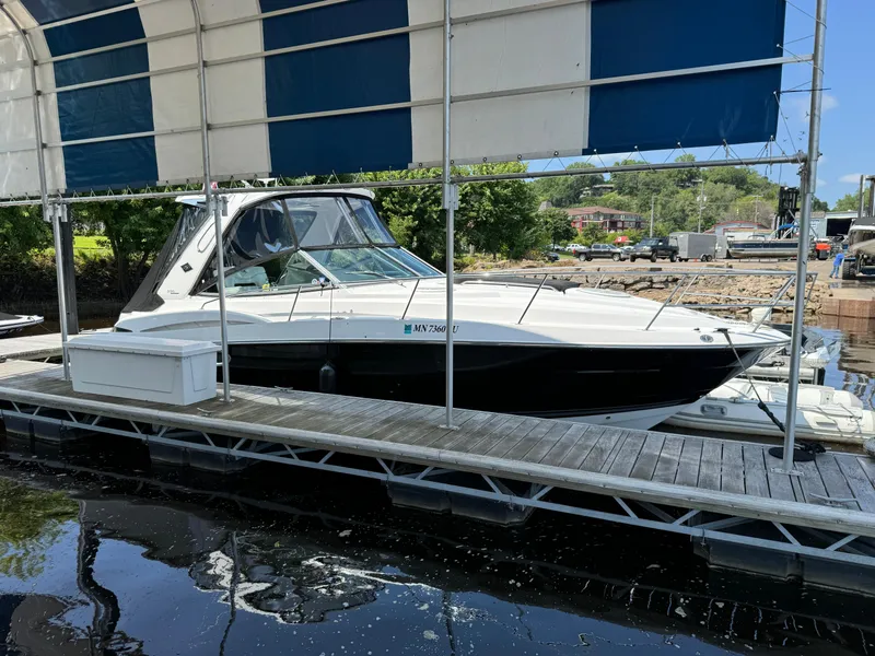 Slide: The Image of 2019 Monterey 335 SY boat docked under a canopy on a sunny day. - 27