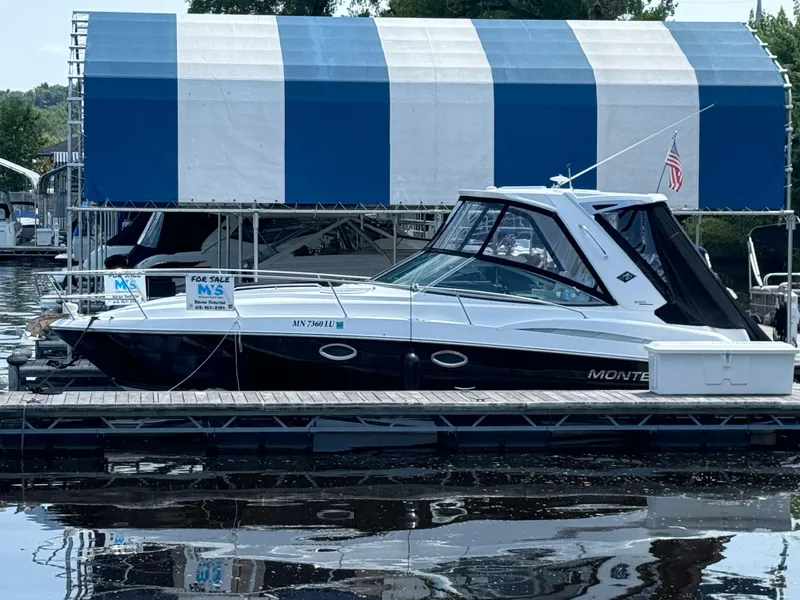Slide: The Image of 2019 Monterey 335 SY boat docked, for sale sign visible, under blue and white canopy. - 30