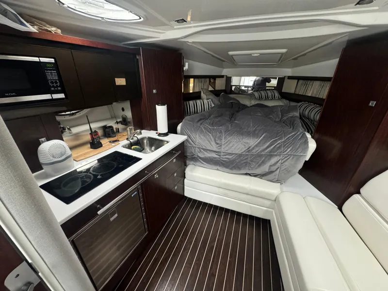 Slide: The Image of Luxurious interior of a 2019 Monterey 335 SY yacht with kitchen and cozy sleeping area. - 33