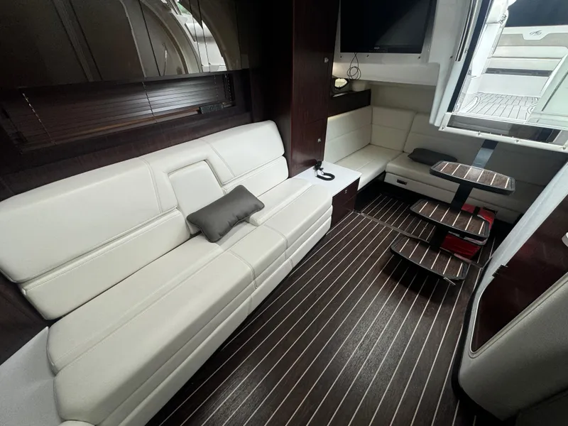 Slide: The Image of Luxurious interior of a 2019 Monterey 335 SY yacht with white seating and wooden flooring. - 35