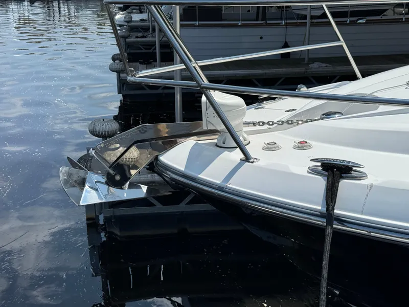 Slide: The Image of 2019 Monterey 335 SY boat docked, featuring sleek bow design and stainless steel anchor. - 6