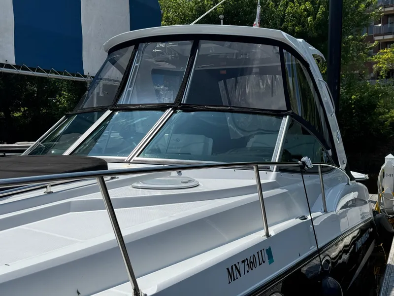 Slide: The Image of 2019 Monterey 335 SY boat with sleek design and tinted windows, docked outdoors. - 7