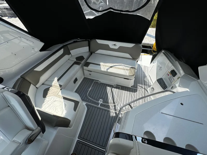 Slide: The Image of 2019 Monterey 335 SY boat interior with cushioned seating and sleek design. - 8
