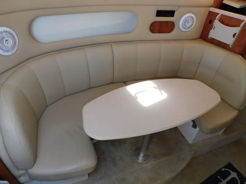 Slide: The Image of 2002 Rinker 310 Fiesta Vee interior with beige leather seating and table. - 36