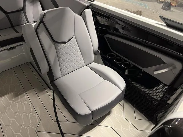 Slide: The Image of 2024 Yamaha Boats 255XE interior with sleek gray seating and modern design. - 14