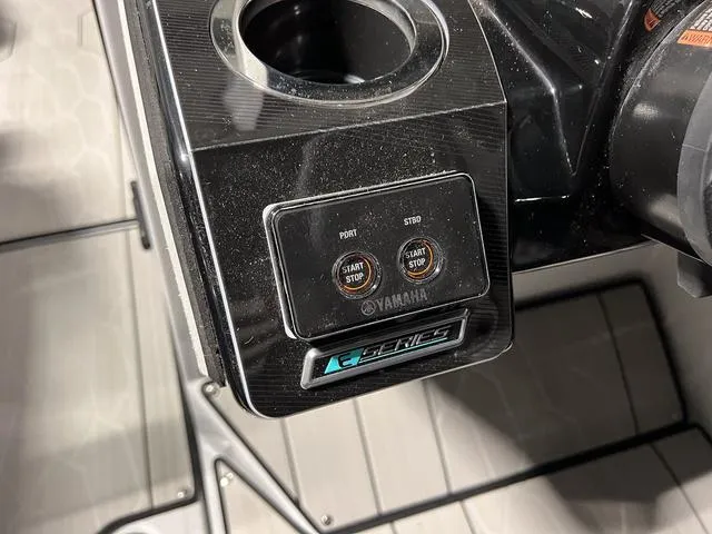 Slide: The Image of Close-up of 2024 Yamaha Boats 255XE control panel with start/stop buttons. - 20